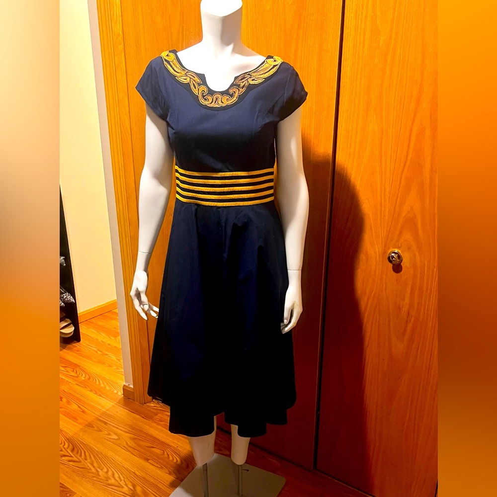 Dark navy color dress with yellow strip waist and embroiled around its neck.
